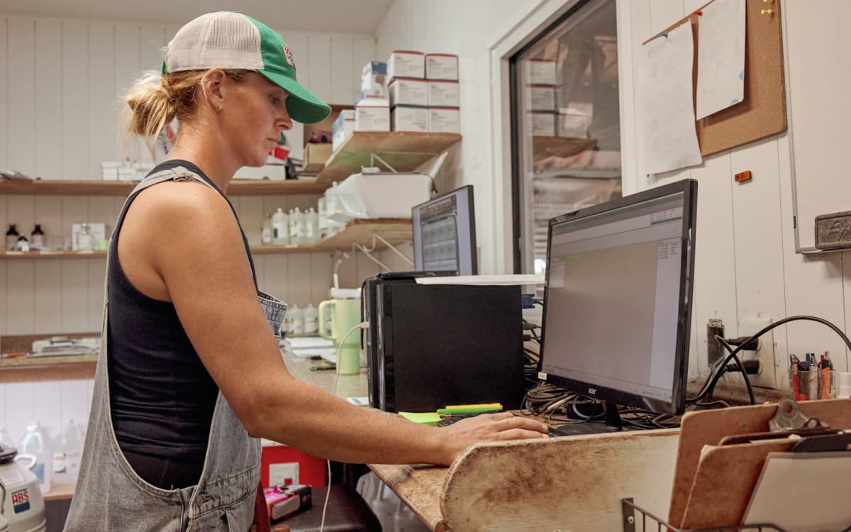Farm store owner reviewing accounts on the computer in her back office